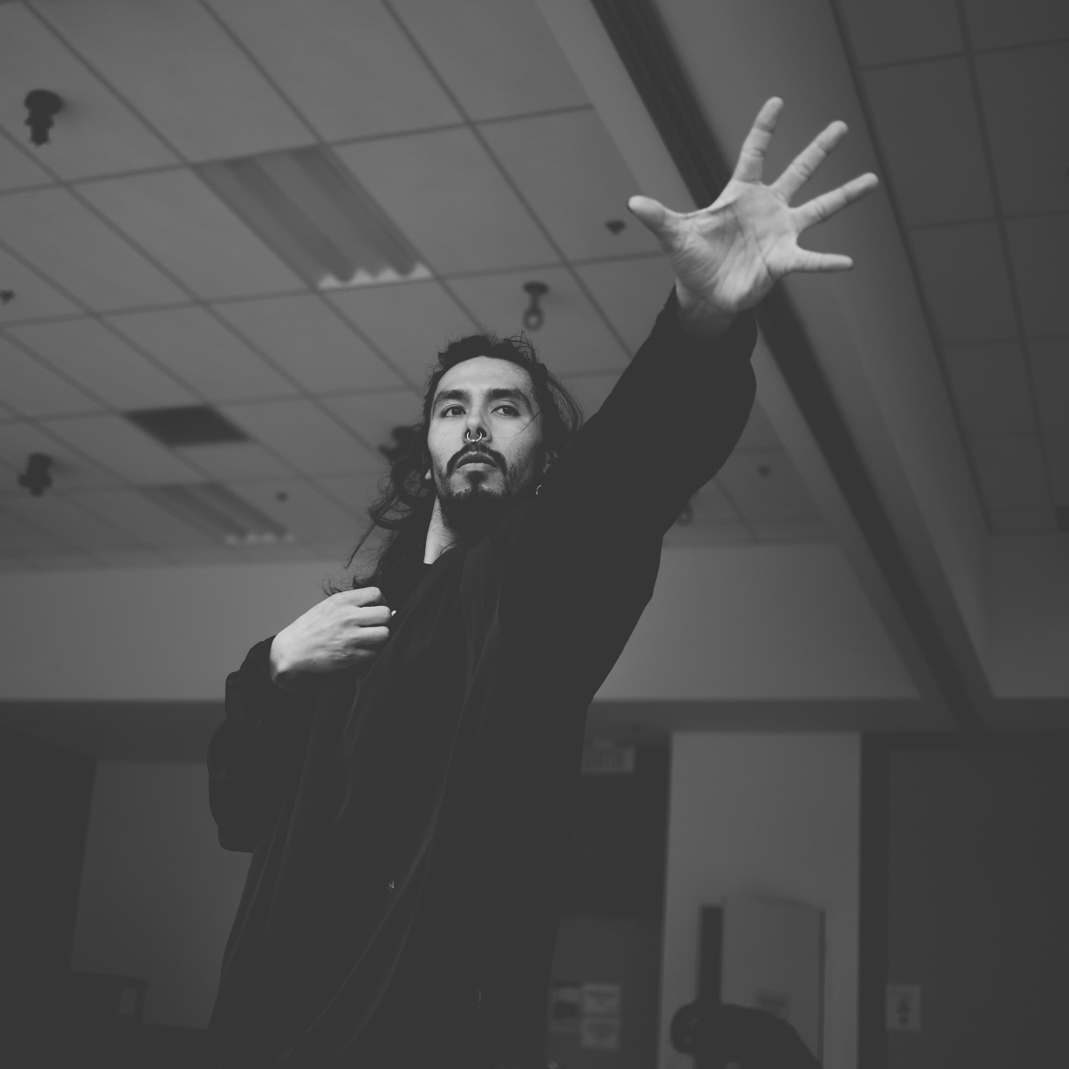 Niki reaching an open hand toward the camera